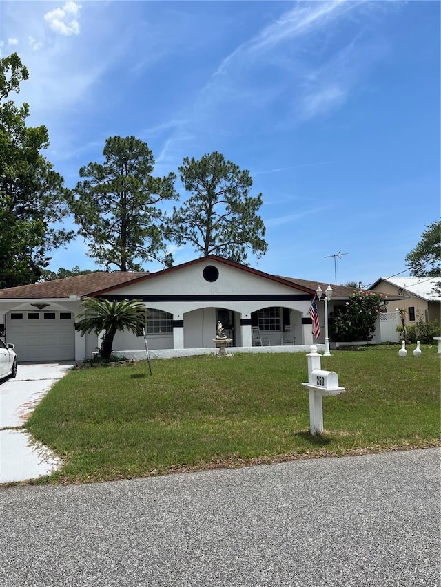 250 Beechwood Ln, Palm Coast, FL 32137 - view of front of home with a front yard, stucco siding, a garage, and driveway