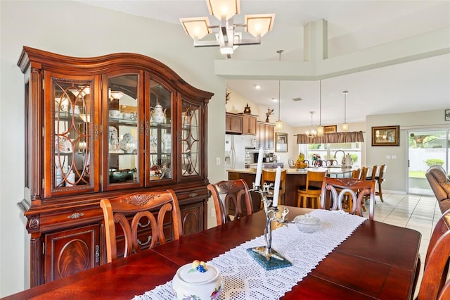 118 Pine Grove Dr, Palm Coast, FL 32164 - dining area featuring a chandelier, healthy amount of natural light, light tile patterned flooring, and lofted ceiling