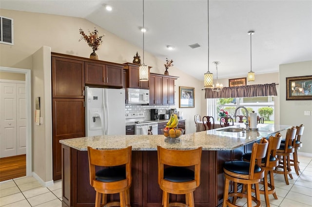 118 Pine Grove Dr, Palm Coast, FL 32164 - kitchen featuring white appliances, vaulted ceiling, light tile patterned floors, a sink, and a chandelier