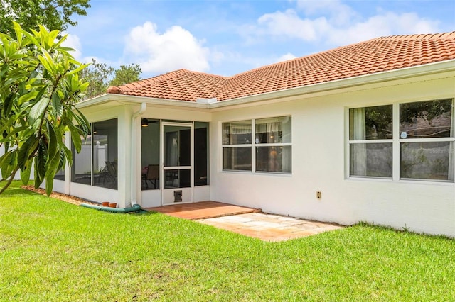118 Pine Grove Dr, Palm Coast, FL 32164 - back of property featuring a tiled roof, stucco siding, a sunroom, and a lawn