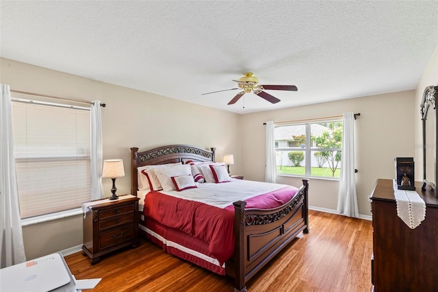 118 Pine Grove Dr, Palm Coast, FL 32164 - bedroom featuring hardwood / wood-style floors, a ceiling fan, baseboards, and a textured ceiling