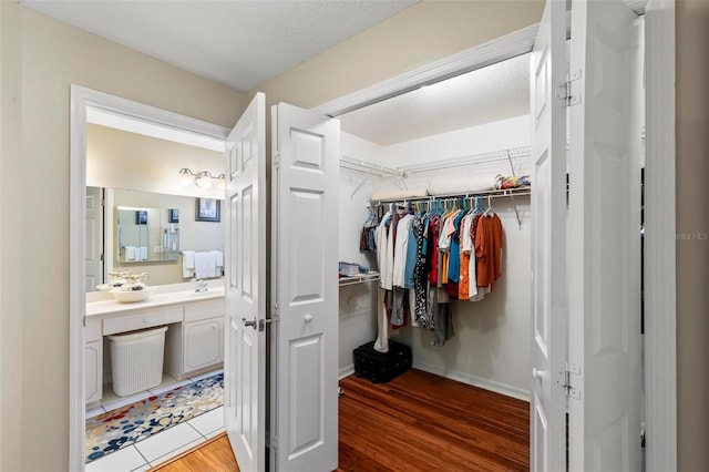 118 Pine Grove Dr, Palm Coast, FL 32164 - walk in closet featuring light wood-style flooring and a sink
