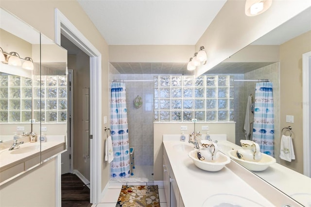 118 Pine Grove Dr, Palm Coast, FL 32164 - bathroom featuring a tile shower, double vanity, and tile patterned floors