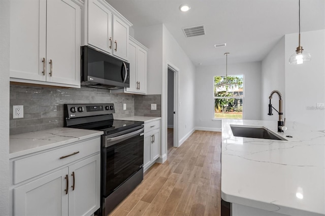 2 Seamanship Trl, Palm Coast, FL 32164 - kitchen featuring black microwave, stainless steel electric range oven, a sink, light wood-style flooring, and backsplash