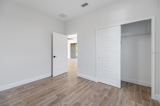 2 Seamanship Trl, Palm Coast, FL 32164 - unfurnished bedroom with light wood-style flooring, baseboards, and a closet