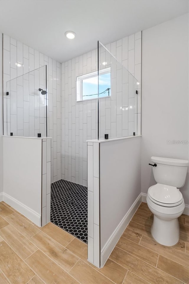 2 Seamanship Trl, Palm Coast, FL 32164 - full bath with a walk in shower, toilet, wood finished floors, and baseboards