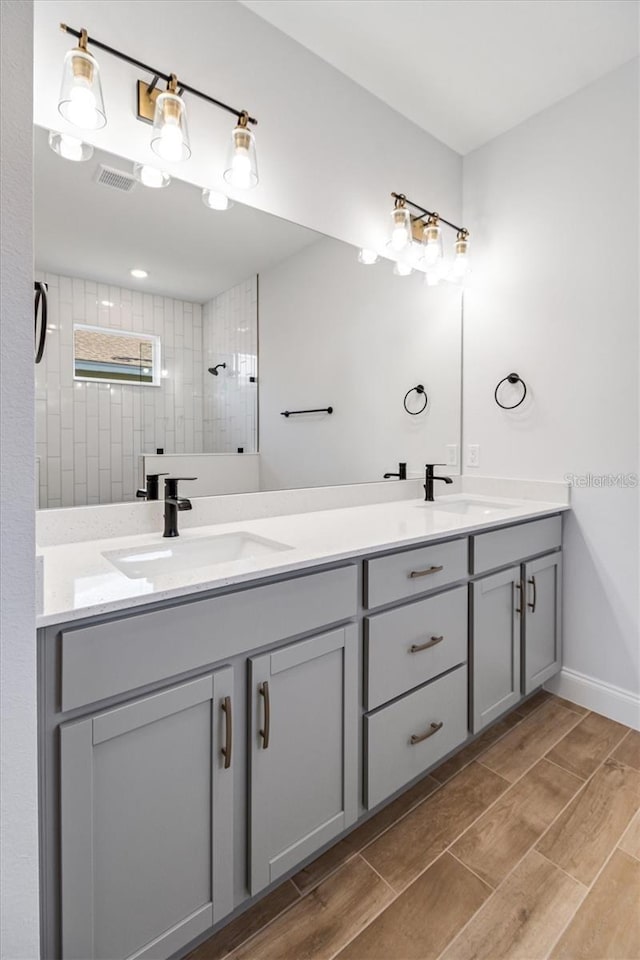 2 Seamanship Trl, Palm Coast, FL 32164 - full bathroom with double vanity, wood tiled floors, a tile shower, and baseboards