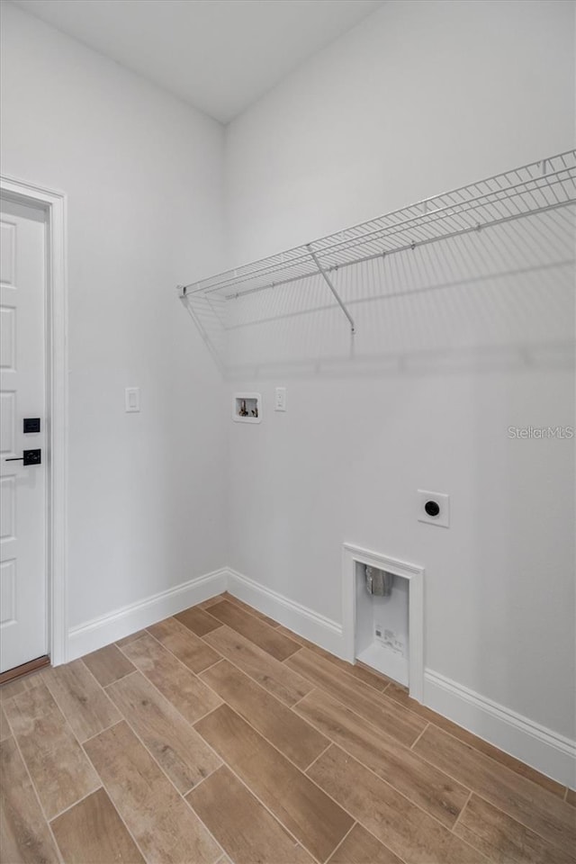 2 Seamanship Trl, Palm Coast, FL 32164 - laundry area featuring electric dryer hookup, washer hookup, wood finish floors, and baseboards
