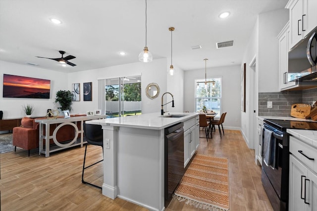 2 Seamanship Trl, Palm Coast, FL 32164 - kitchen with a sink, electric stove, dishwashing machine, stainless steel microwave, and light countertops