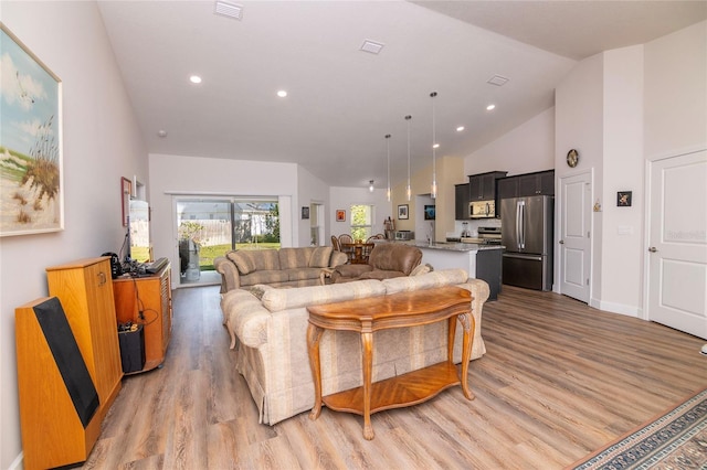 15 Raleigh Dr, Palm Coast, FL 32164 - living area featuring light wood finished floors, high vaulted ceiling, and recessed lighting