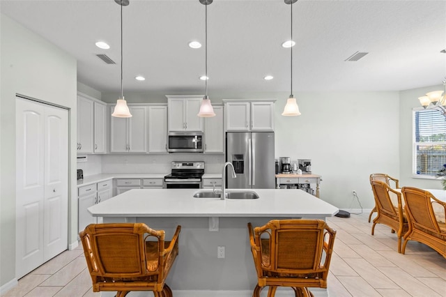 9 Port Royal Dr, Palm Coast, FL 32164 - kitchen featuring appliances with stainless steel finishes, light countertops, recessed lighting, light tile patterned floors, and a breakfast bar area