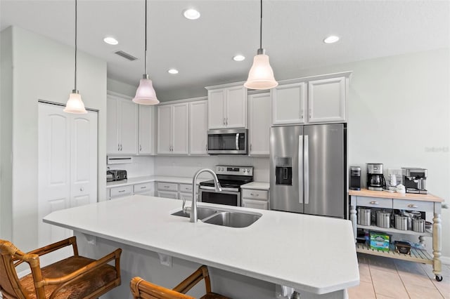 9 Port Royal Dr, Palm Coast, FL 32164 - kitchen featuring stainless steel appliances, a kitchen breakfast bar, light countertops, recessed lighting, and decorative light fixtures