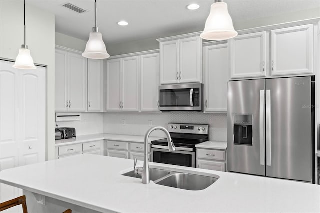 9 Port Royal Dr, Palm Coast, FL 32164 - kitchen featuring appliances with stainless steel finishes, light countertops, white cabinetry, decorative light fixtures, and recessed lighting