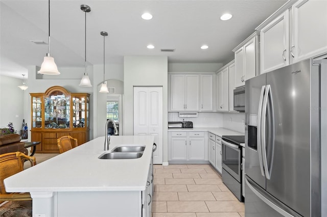 9 Port Royal Dr, Palm Coast, FL 32164 - kitchen featuring appliances with stainless steel finishes, light countertops, recessed lighting, white cabinets, and decorative backsplash