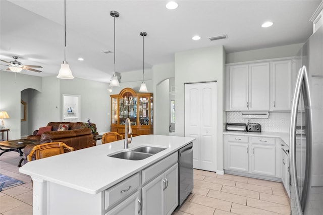9 Port Royal Dr, Palm Coast, FL 32164 - kitchen featuring appliances with stainless steel finishes, arched walkways, light tile patterned floors, light countertops, and open floor plan