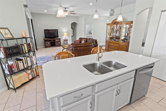 9 Port Royal Dr, Palm Coast, FL 32164 - kitchen with stainless steel dishwasher, arched walkways, light tile patterned flooring, light countertops, and recessed lighting