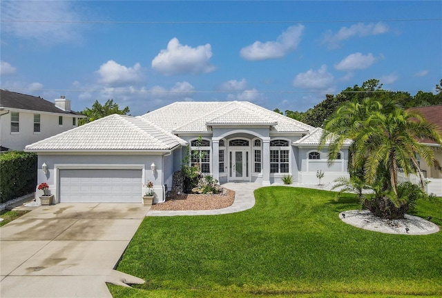 101 Covington Ln, Palm Coast, FL 32137 - view of front of home with a garage, driveway, a front lawn, and a tiled roof