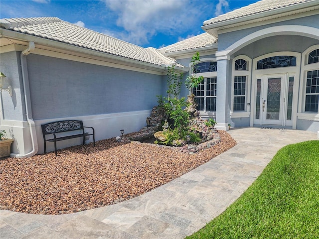 101 Covington Ln, Palm Coast, FL 32137 - entrance to property with a tile roof