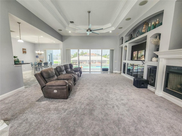 101 Covington Ln, Palm Coast, FL 32137 - living room with carpet floors, ceiling fan, a raised ceiling, baseboards, and crown molding