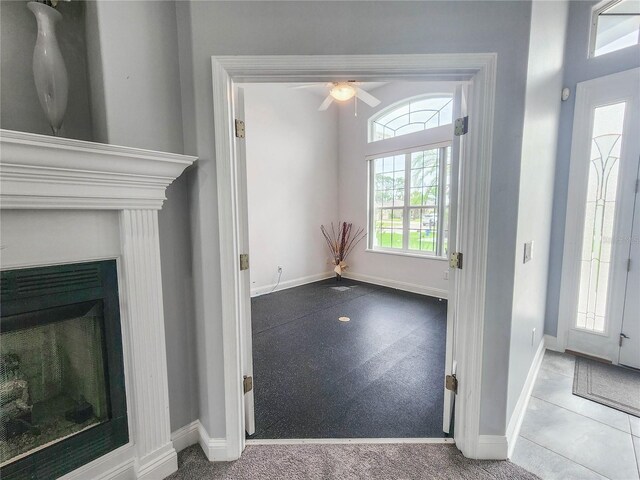 101 Covington Ln, Palm Coast, FL 32137 - carpeted foyer featuring ceiling fan, baseboards, and a fireplace