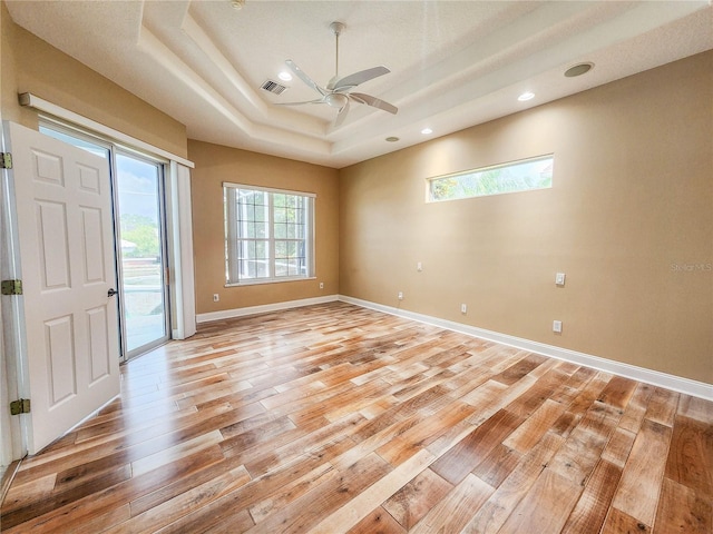 101 Covington Ln, Palm Coast, FL 32137 - spare room with a raised ceiling, light wood-style flooring, a ceiling fan, recessed lighting, and baseboards