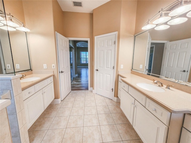 101 Covington Ln, Palm Coast, FL 32137 - full bathroom with two vanities, tile patterned flooring, and baseboards