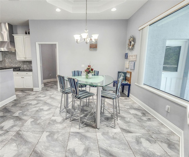 101 Covington Ln, Palm Coast, FL 32137 - dining room with a chandelier, recessed lighting, light marble finish flooring, baseboards, and a tray ceiling