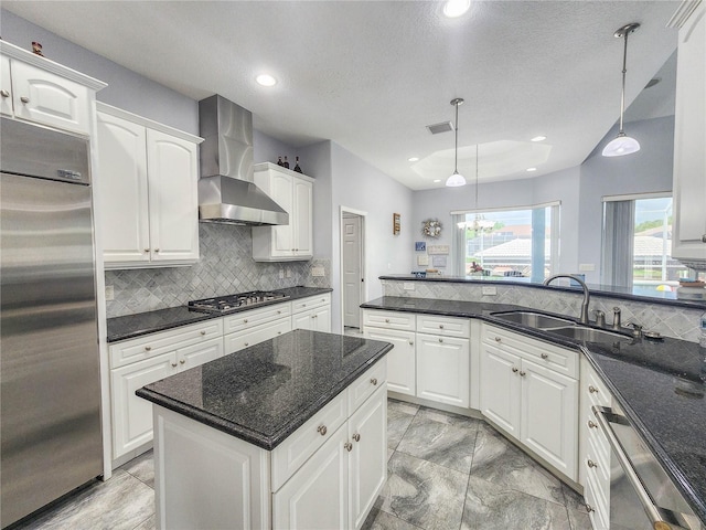 101 Covington Ln, Palm Coast, FL 32137 - kitchen with stainless steel appliances, wall chimney range hood, a sink, tasteful backsplash, and white cabinets