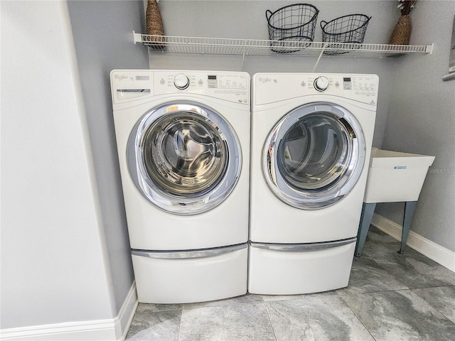 101 Covington Ln, Palm Coast, FL 32137 - laundry room with washing machine and clothes dryer and baseboards