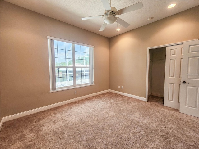 101 Covington Ln, Palm Coast, FL 32137 - unfurnished bedroom featuring light carpet, a closet, recessed lighting, baseboards, and a textured ceiling