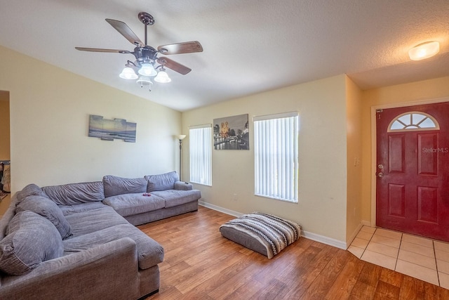 19 Rydell Ln, Palm Coast, FL 32164 - living room featuring a ceiling fan, light wood finished floors, and lofted ceiling