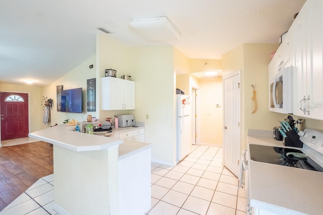 19 Rydell Ln, Palm Coast, FL 32164 - kitchen featuring white appliances, a peninsula, white cabinetry, light countertops, and light tile patterned floors