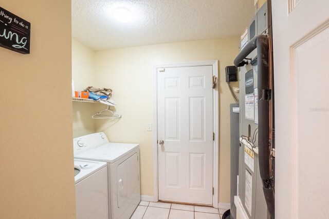 19 Rydell Ln, Palm Coast, FL 32164 - laundry area with washer and clothes dryer, light tile patterned flooring, and a textured ceiling