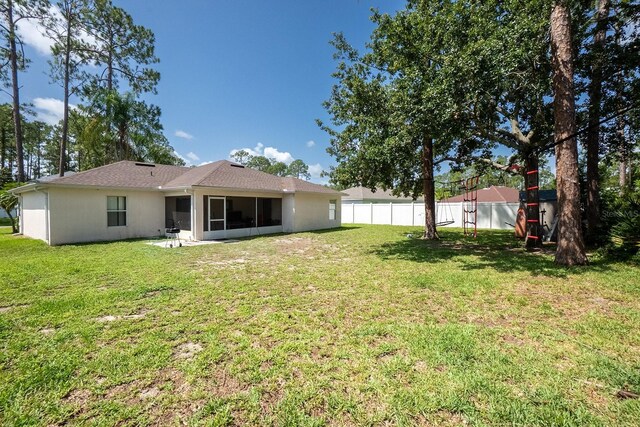 19 Rydell Ln, Palm Coast, FL 32164 - rear view of property with a sunroom and stucco siding
