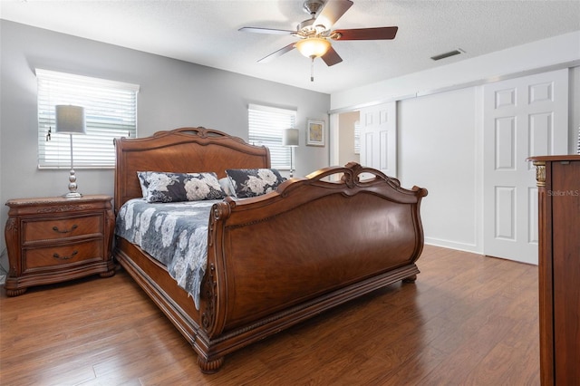12 Fernwood Ln, Palm Coast, FL 32137 - bedroom with wood finished floors, a closet, ceiling fan, and a textured ceiling