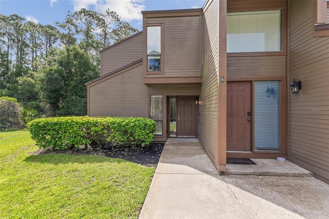 7 Sherbury Ct Unit 7, Palm Coast, FL 32137 - view of exterior entry featuring a yard