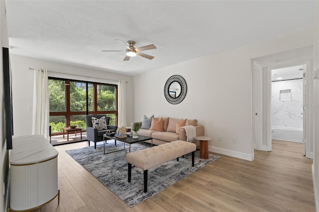 7 Sherbury Ct Unit 7, Palm Coast, FL 32137 - living area featuring a ceiling fan, light wood-style flooring, and baseboards
