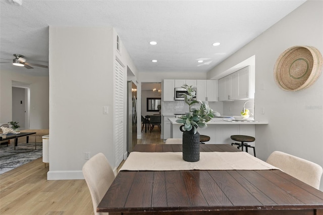 7 Sherbury Ct Unit 7, Palm Coast, FL 32137 - dining room with light wood-style flooring, recessed lighting, ceiling fan, and baseboards