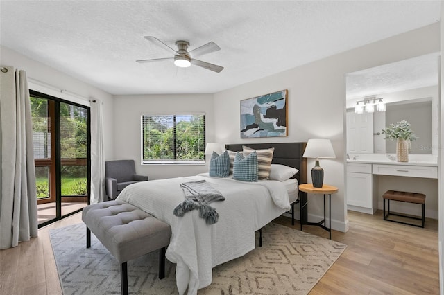 7 Sherbury Ct Unit 7, Palm Coast, FL 32137 - bedroom featuring light wood-style floors, a textured ceiling, and a ceiling fan