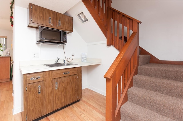 7 Sherbury Ct Unit 7, Palm Coast, FL 32137 - kitchen featuring a sink, black microwave, light wood-style floors, and light countertops
