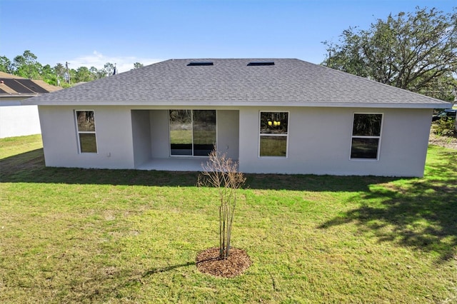 52 Pershing Ln, Palm Coast, FL 32164 - rear view of house featuring roof with shingles, stucco siding, and a patio