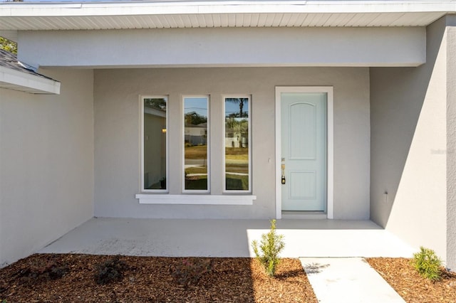 52 Pershing Ln, Palm Coast, FL 32164 - property entrance with stucco siding