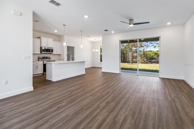 52 Pershing Ln, Palm Coast, FL 32164 - unfurnished living room featuring ceiling fan, dark wood-style floors, and recessed lighting