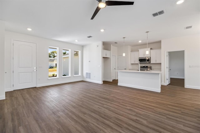 52 Pershing Ln, Palm Coast, FL 32164 - unfurnished living room with dark wood-type flooring, recessed lighting, and a ceiling fan