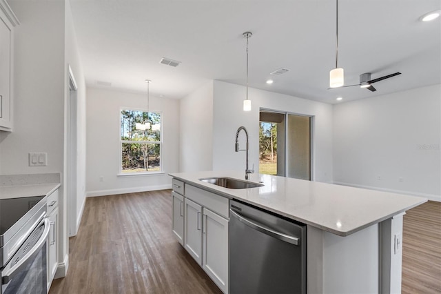 52 Pershing Ln, Palm Coast, FL 32164 - kitchen featuring appliances with stainless steel finishes, healthy amount of natural light, dark wood-type flooring, pendant lighting, and recessed lighting