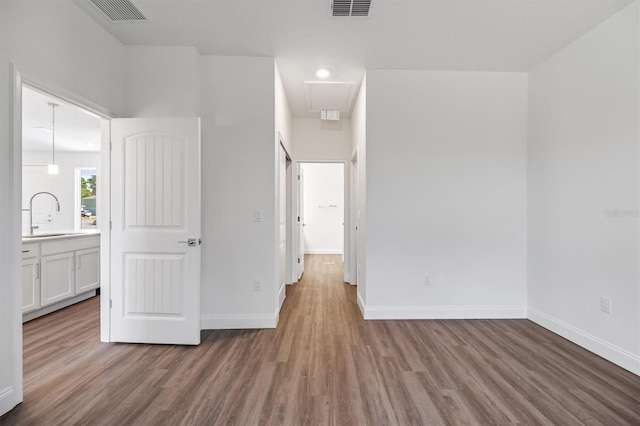 52 Pershing Ln, Palm Coast, FL 32164 - unfurnished bedroom with wood finished floors and attic access