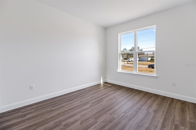 52 Pershing Ln, Palm Coast, FL 32164 - empty room with dark wood-type flooring and baseboards