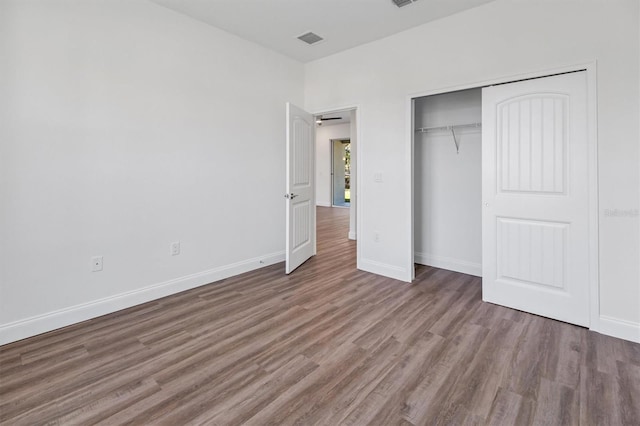 52 Pershing Ln, Palm Coast, FL 32164 - unfurnished bedroom featuring wood finished floors and a closet