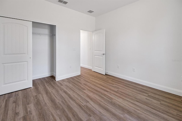 52 Pershing Ln, Palm Coast, FL 32164 - unfurnished bedroom featuring wood finished floors and a closet