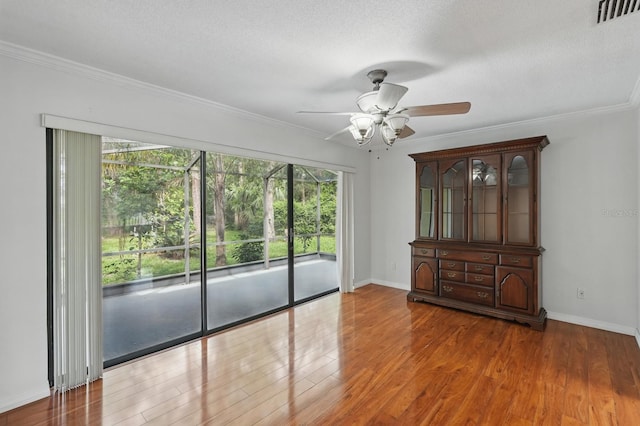 131 Boulder Rock Dr, Palm Coast, FL 32137 - empty room with wood finished floors, a ceiling fan, and crown molding